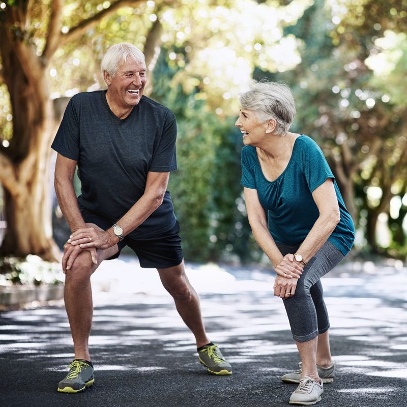 Senior couple stretching before a run